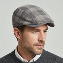 Dupplin Argyle Flat Cap Corduroy lilac/grey | Place this hat on the head of a male. The image should be taken in a studio setting on a light grey backround.
