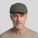 Graph Check Flat Cap Charcoal/orange | Place this hat on the head of a male. The image should be taken in a studio setting on a light grey backround.