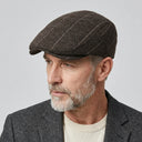 Graph Check Flat Cap Coffee/white | Place this hat on the head of a male. The image should be taken in a studio setting on a light grey backround.