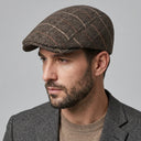 Graph Check Flat Cap Khaki/orange | Place this hat on the head of a male. The image should be taken in a studio setting on a light grey backround.
