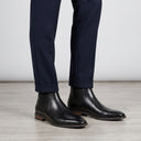 Men's Black Leather Chelsea Slip-on Boots | Professional eCommerce fashion photography of men's formal leather boots being worn by a male model.