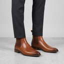 Men's Brass Leather Chelsea Slip-on Boots | Professional eCommerce fashion photography of men's formal leather boots being worn by a male model.
