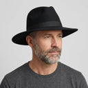 Men's Felt Fedora Hat BLACK | Place this hat on the head of a male. The image should be taken in a studio setting on a light grey backround.