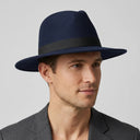 Men's Felt Fedora Hat NAVY | Place this hat on the head of a male. The image should be taken in a studio setting on a light grey backround.