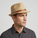 Men's Summer Trilby STRAW BEIGE WITH LEATHER | Place this hat on the head of a male. The image should be taken in a studio setting on a light grey backround.