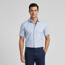 Short Sleeve Shirt GREY | Man wearing this short sleeve shirt. Have the man standing in front of a light grey backround, showing from the knees up.