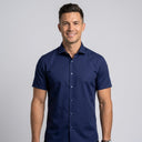 Short Sleeve Shirt NAVY | Man wearing this short sleeve shirt. Have the man standing in front of a light grey backround, showing from the waist up.