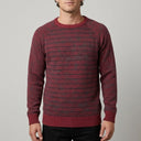 Striped Wool Crew Pullover - Maroon | Man wearing this casual pullover. Have the man standing in front of a light grey backround, showing from the waist up.