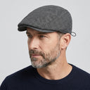 Tattersall Check Flat Cap Black | Place this hat on the head of a male. The image should be taken in a studio setting on a light grey backround.